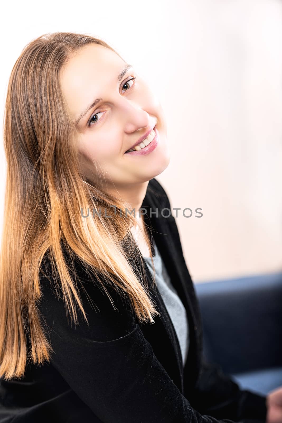 Portrait of elegantly dressed smiling young brunette woman