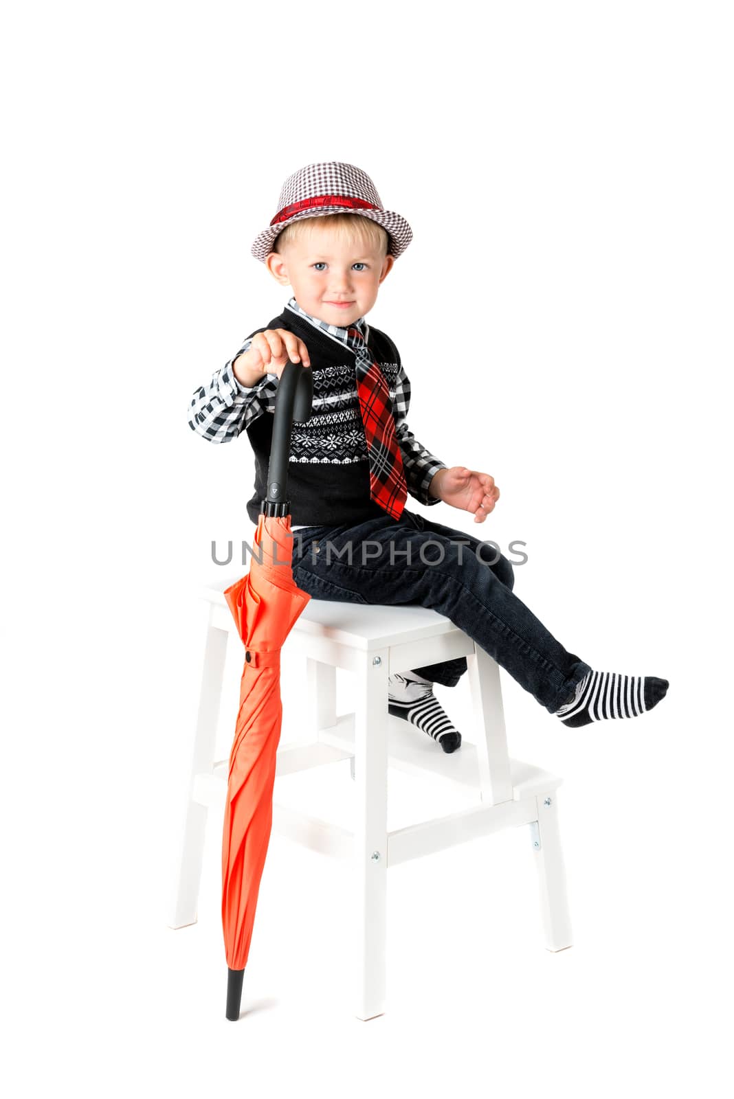 Smiling happy boy with umbrella shot in the studio on a white background