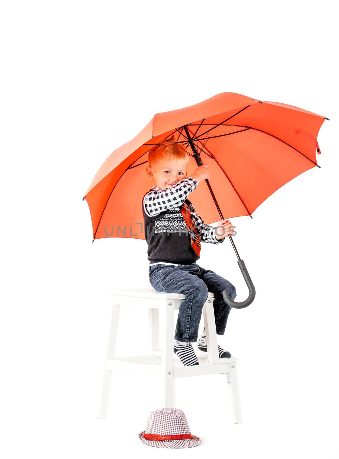 Smiling happy boy with umbrella shot in the studio on a white background
