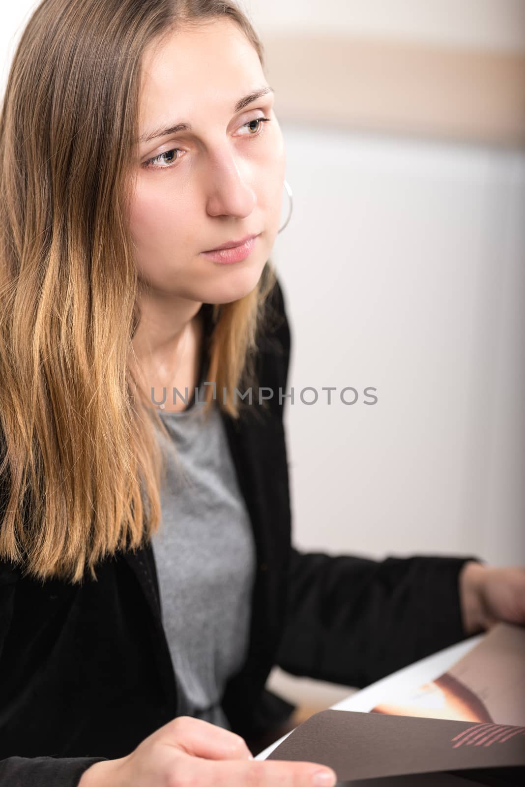 elegantly dressed young brunette woman with magazine by Nanisimova