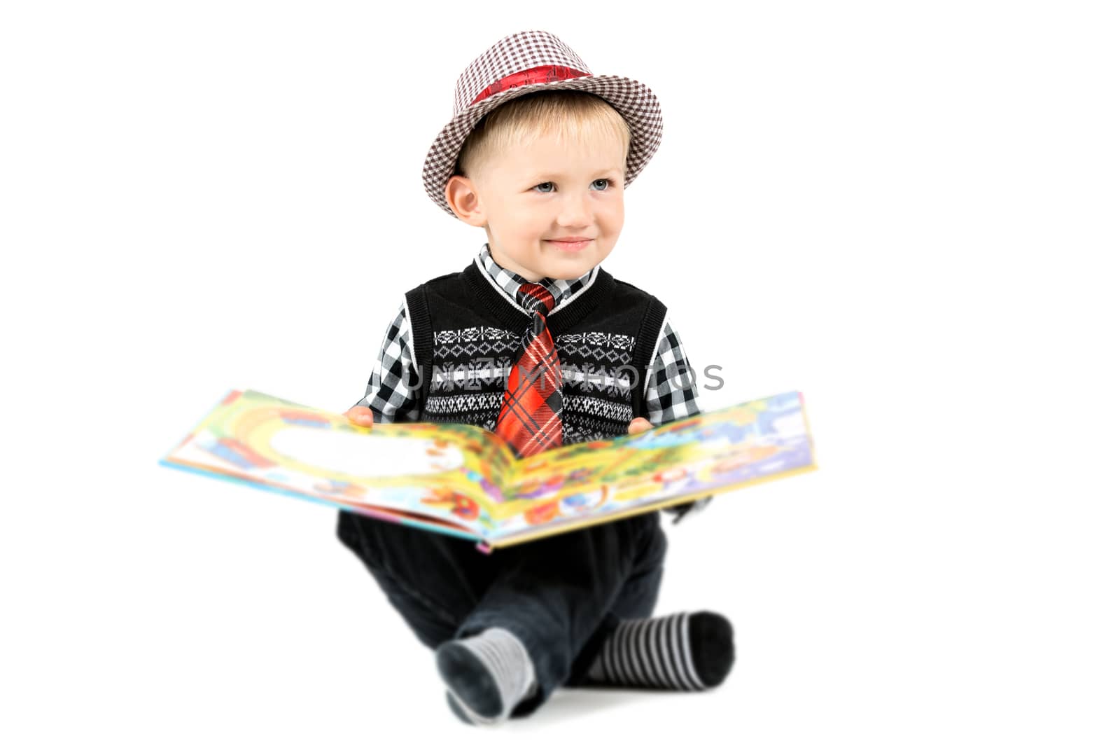 Smiling happy boy with book studio shot isolated on a white back by Nanisimova