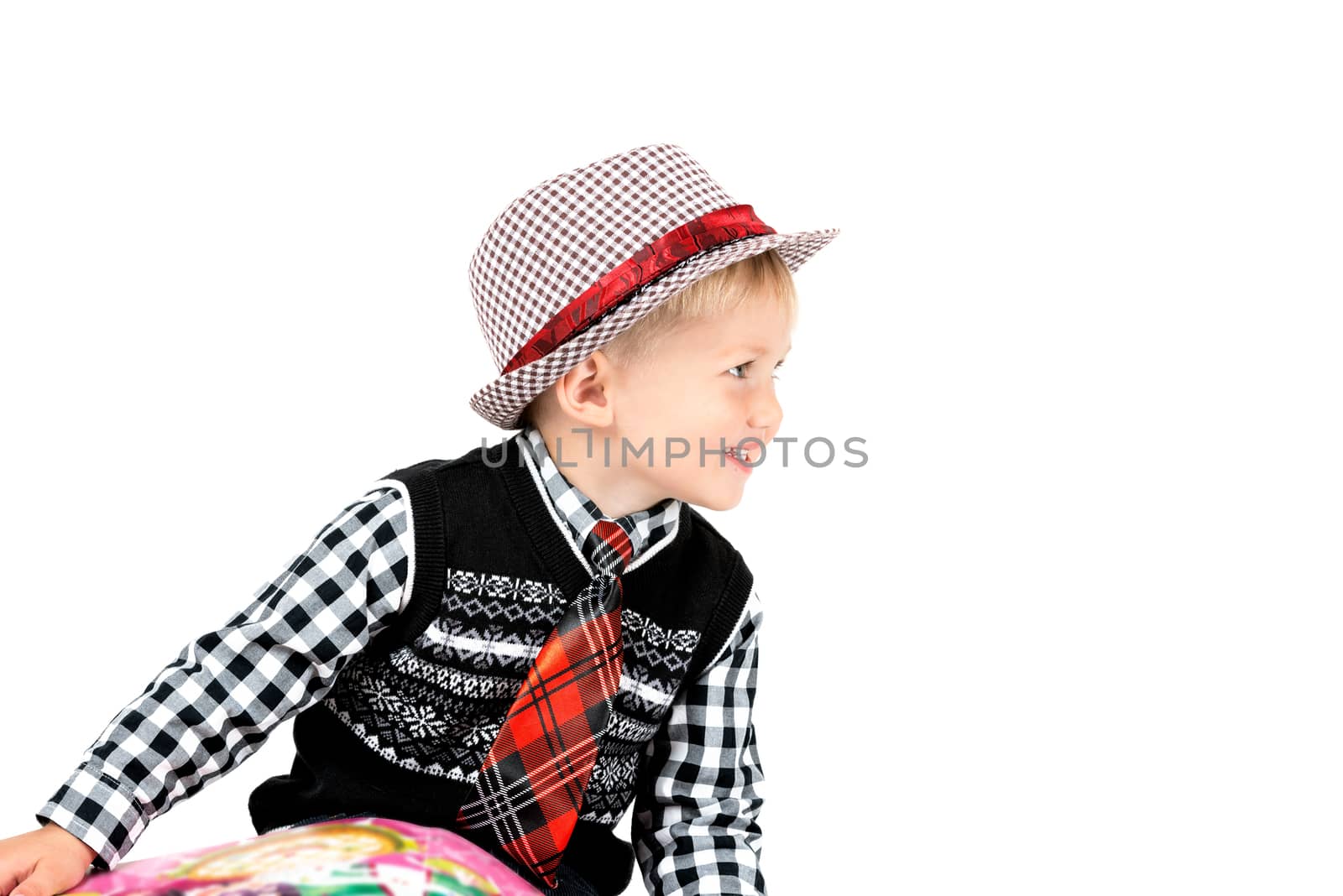 Smiling happy boy in hat and tie shot in the studio on a white background