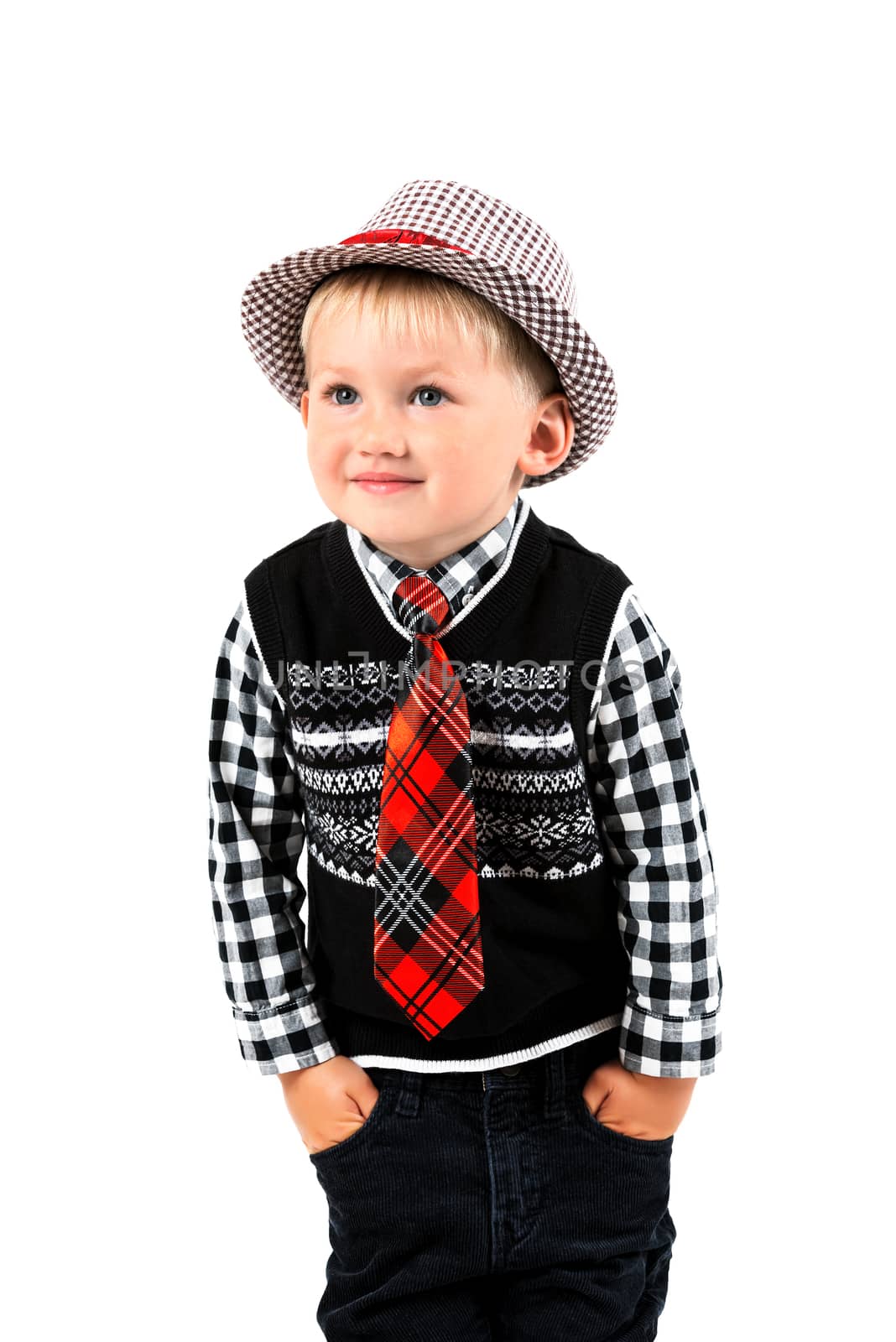Smiling happy boy in hat and tie shot in the studio on a white background