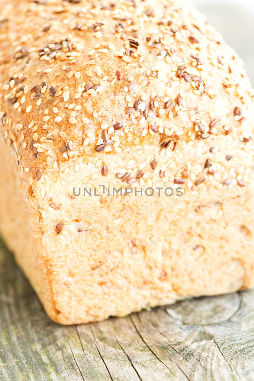 Composition with loaf of bread on wooden table