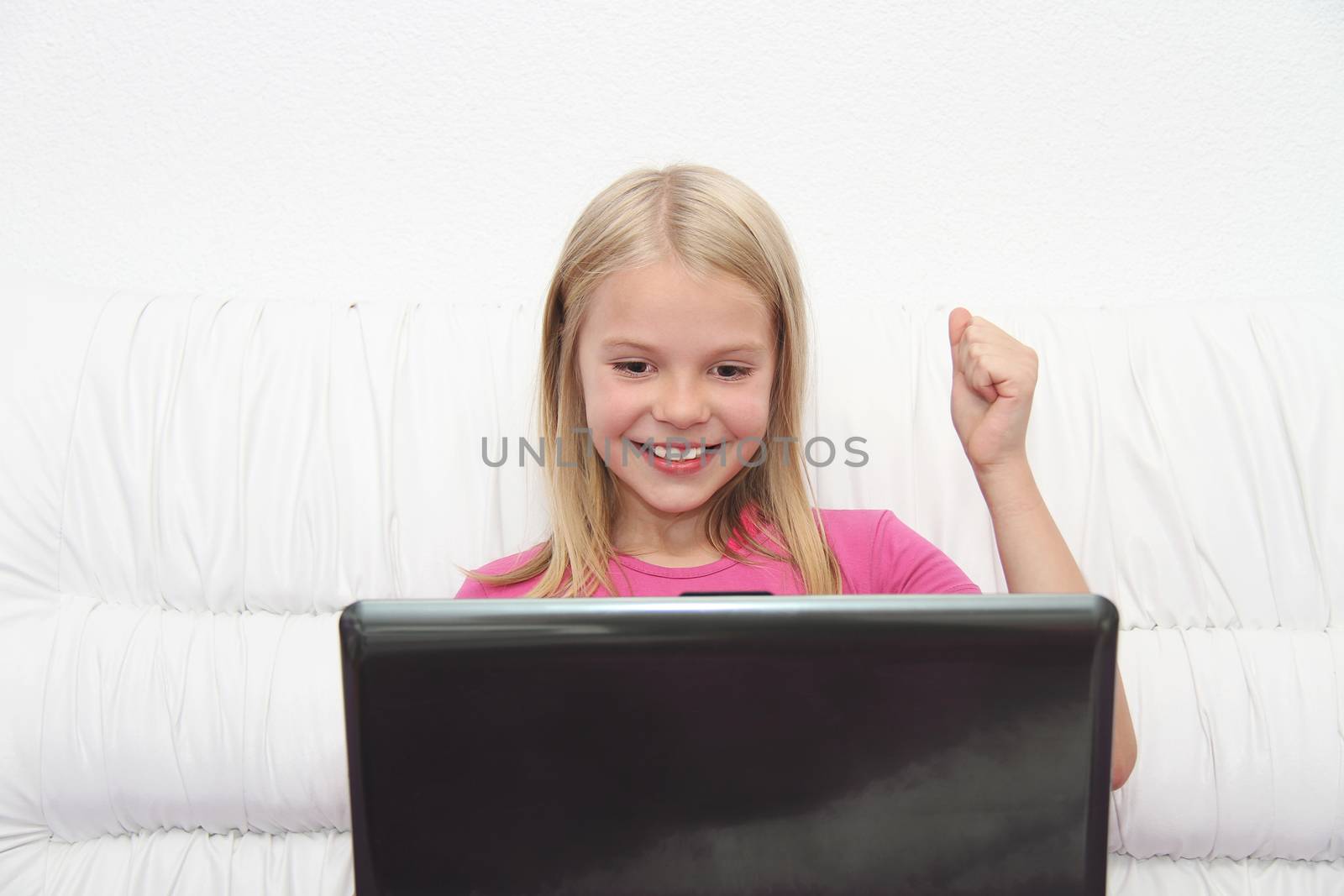 Young Girl Using Laptop At Home