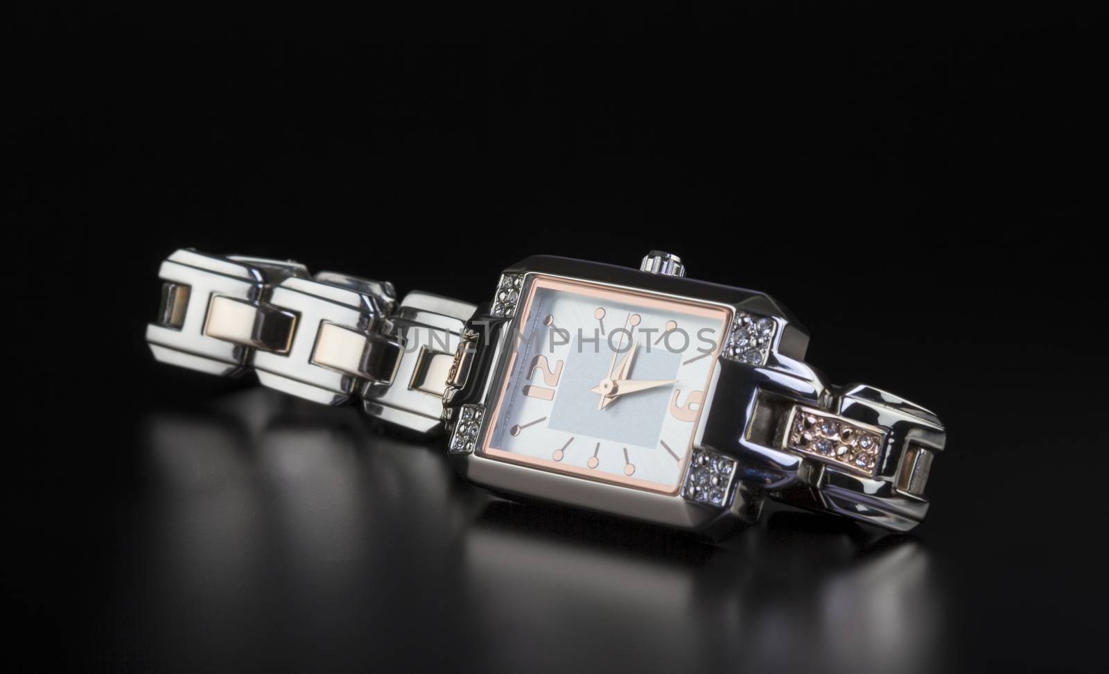 photo luxury woman’s watch on black  by manaemedia