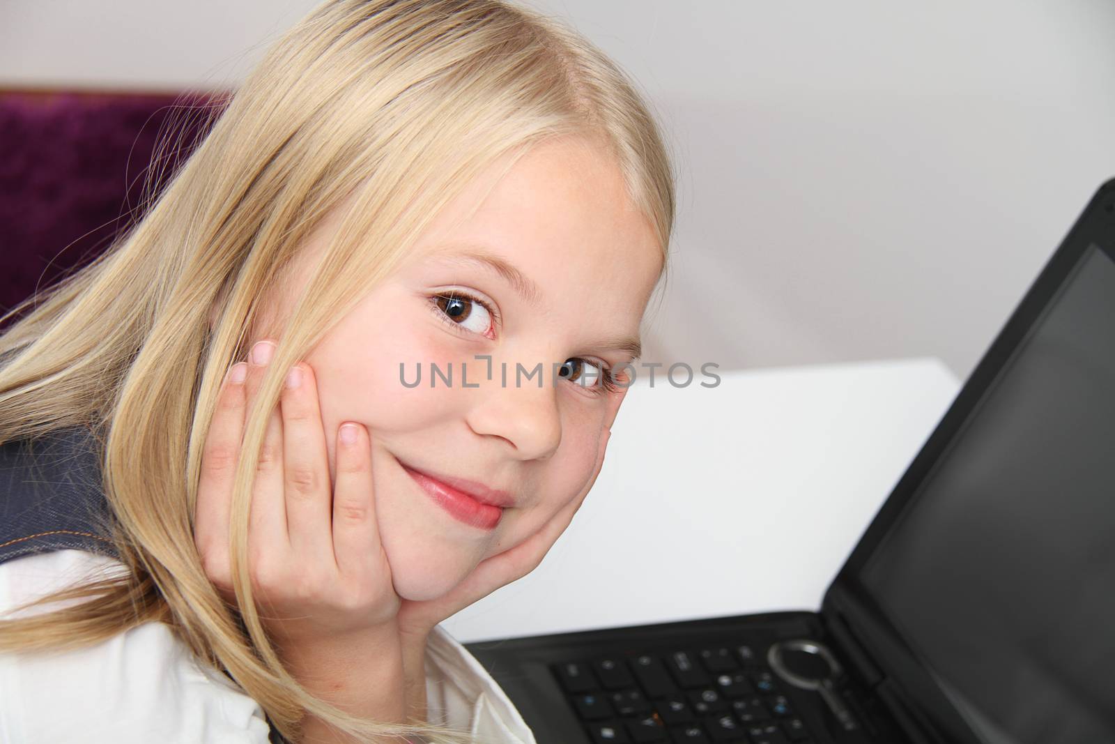 Young Girl Using Laptop At Home