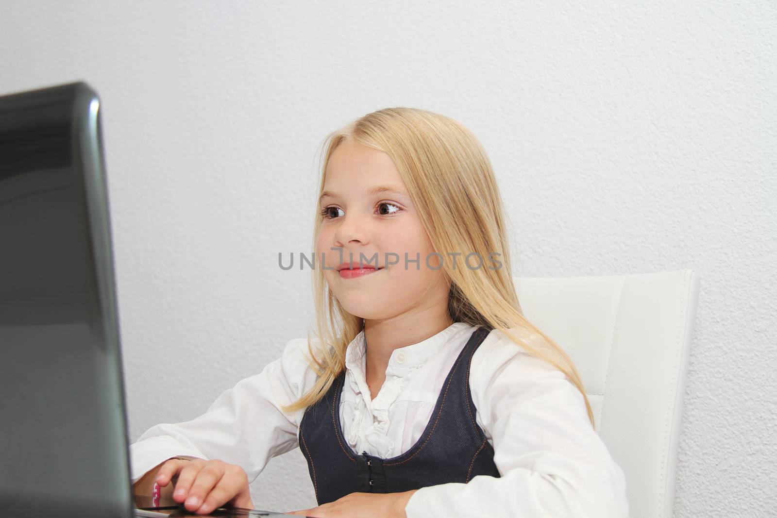 Young Girl Using Laptop At Home by mirzavis