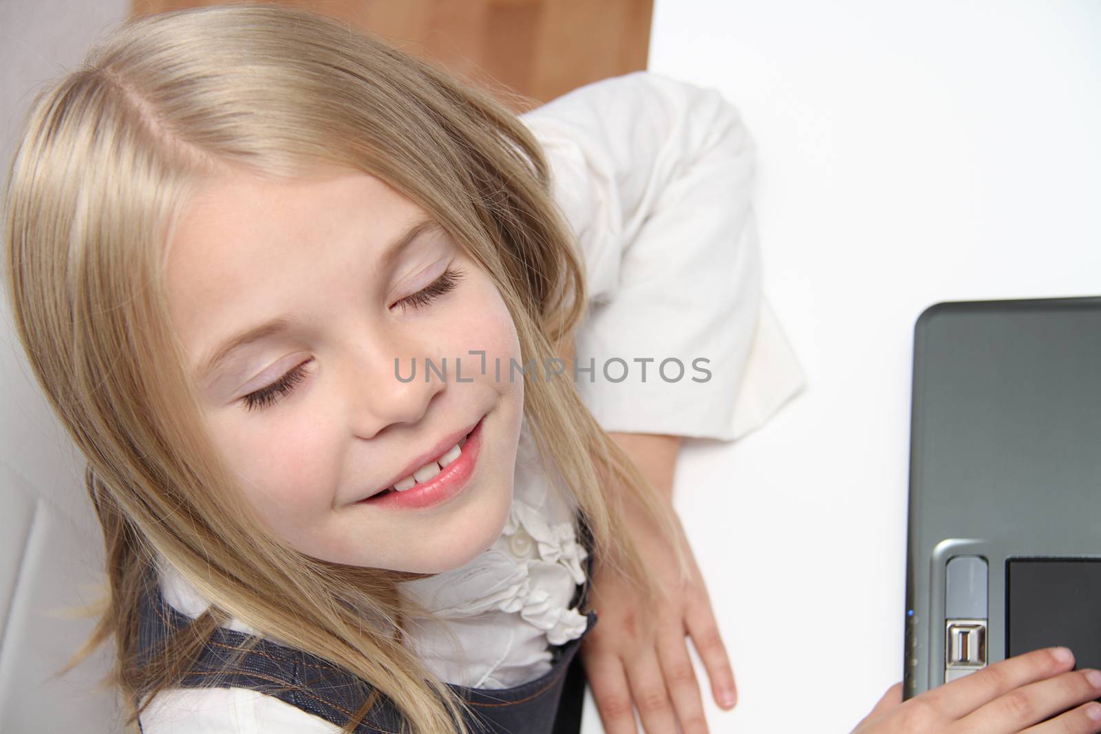 Young Girl Using Laptop At Home by mirzavis