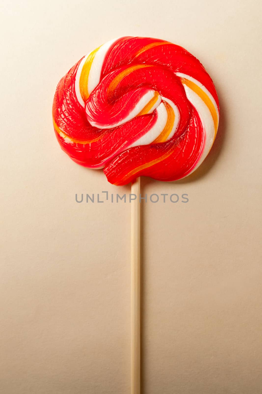 Bright lollipop candy on paper background by Garsya