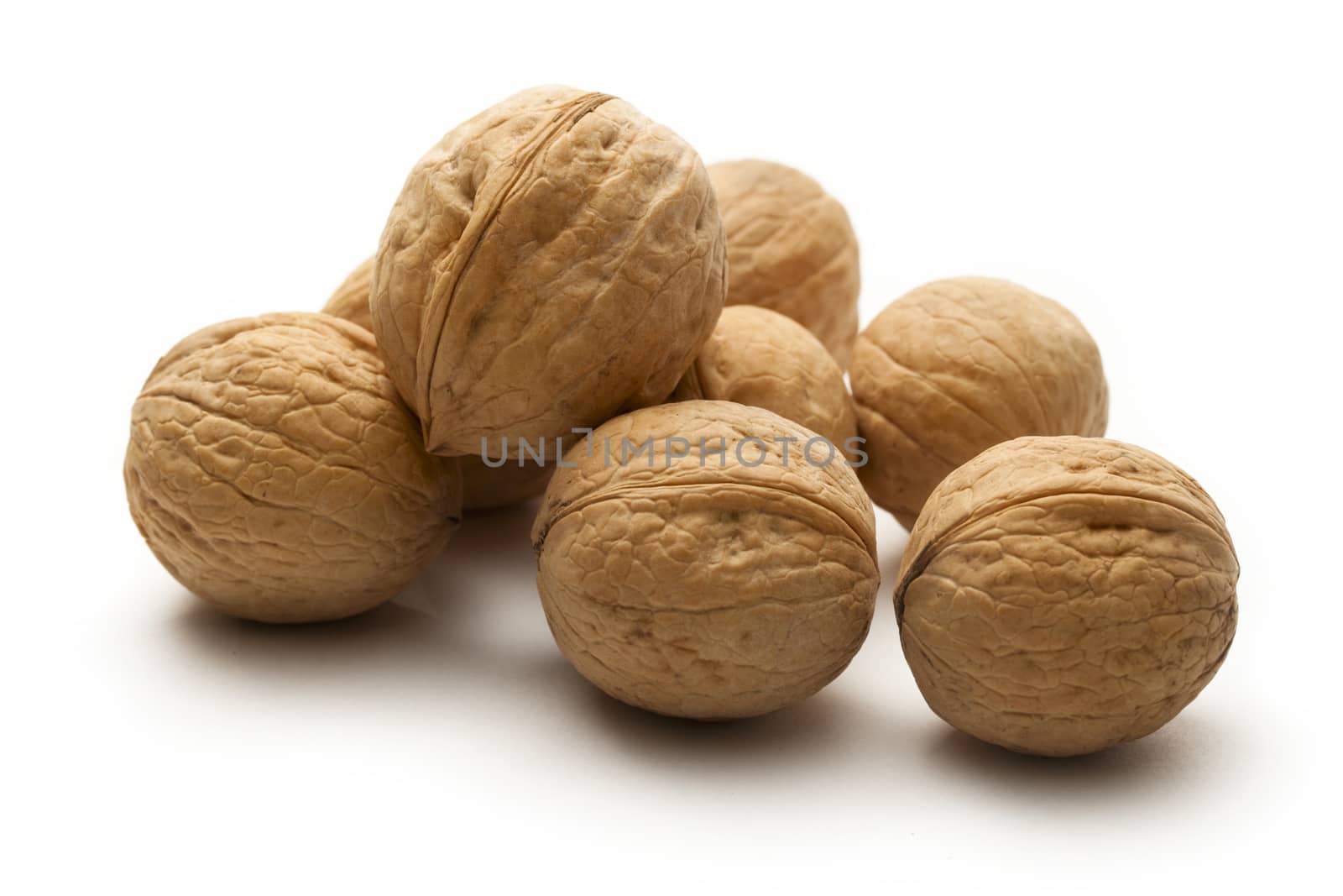 Heap of walnuts on white