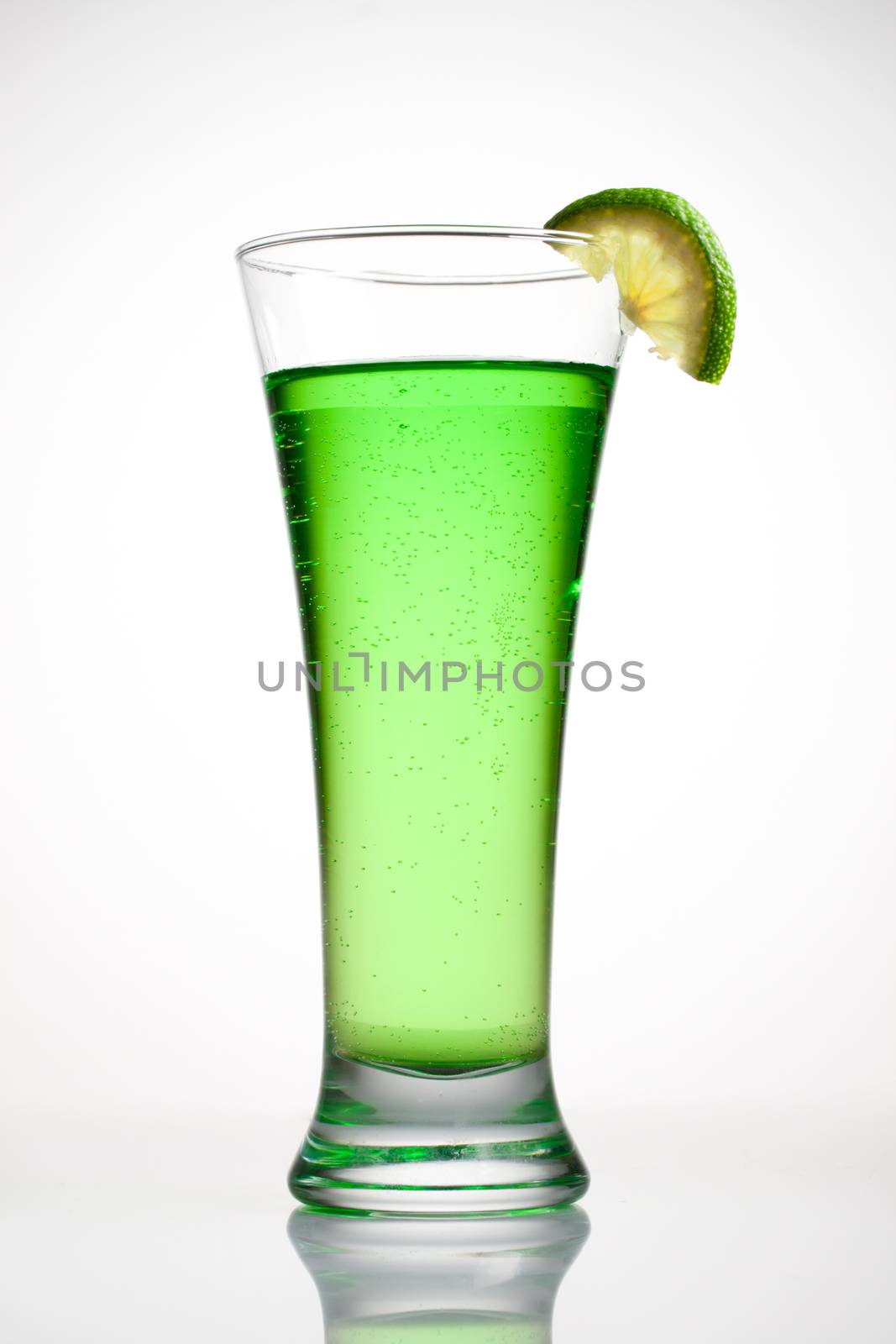 Green cocktail with a slice of lime