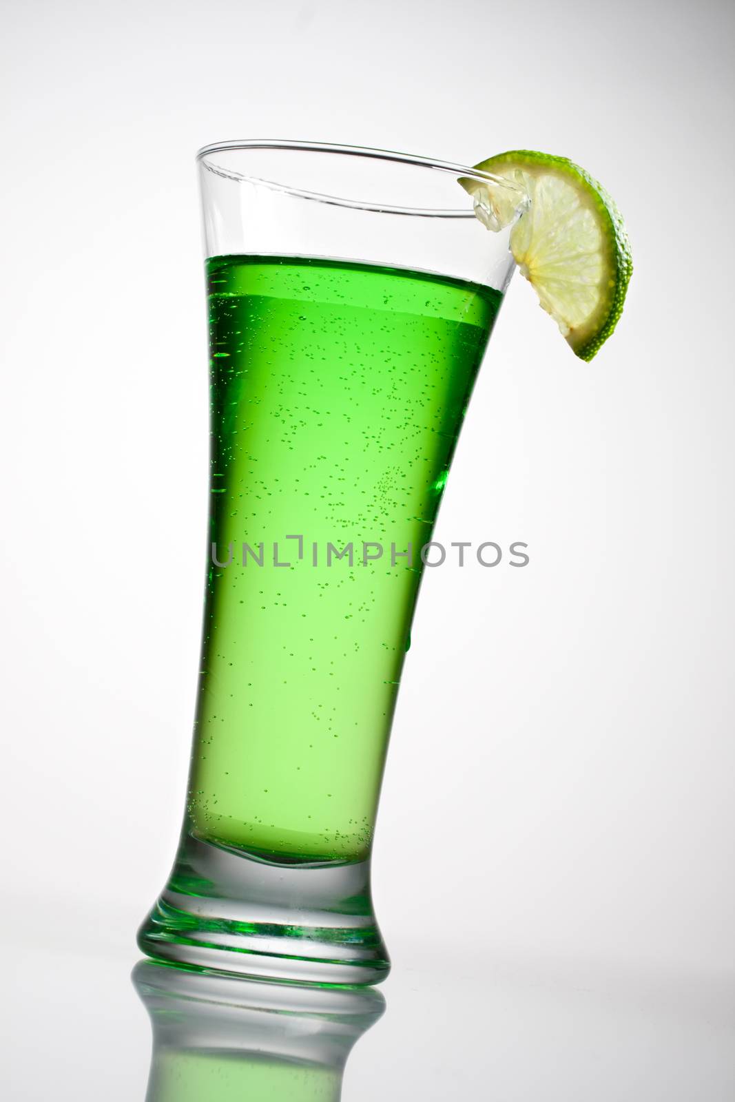 Green cocktail with a slice of lime