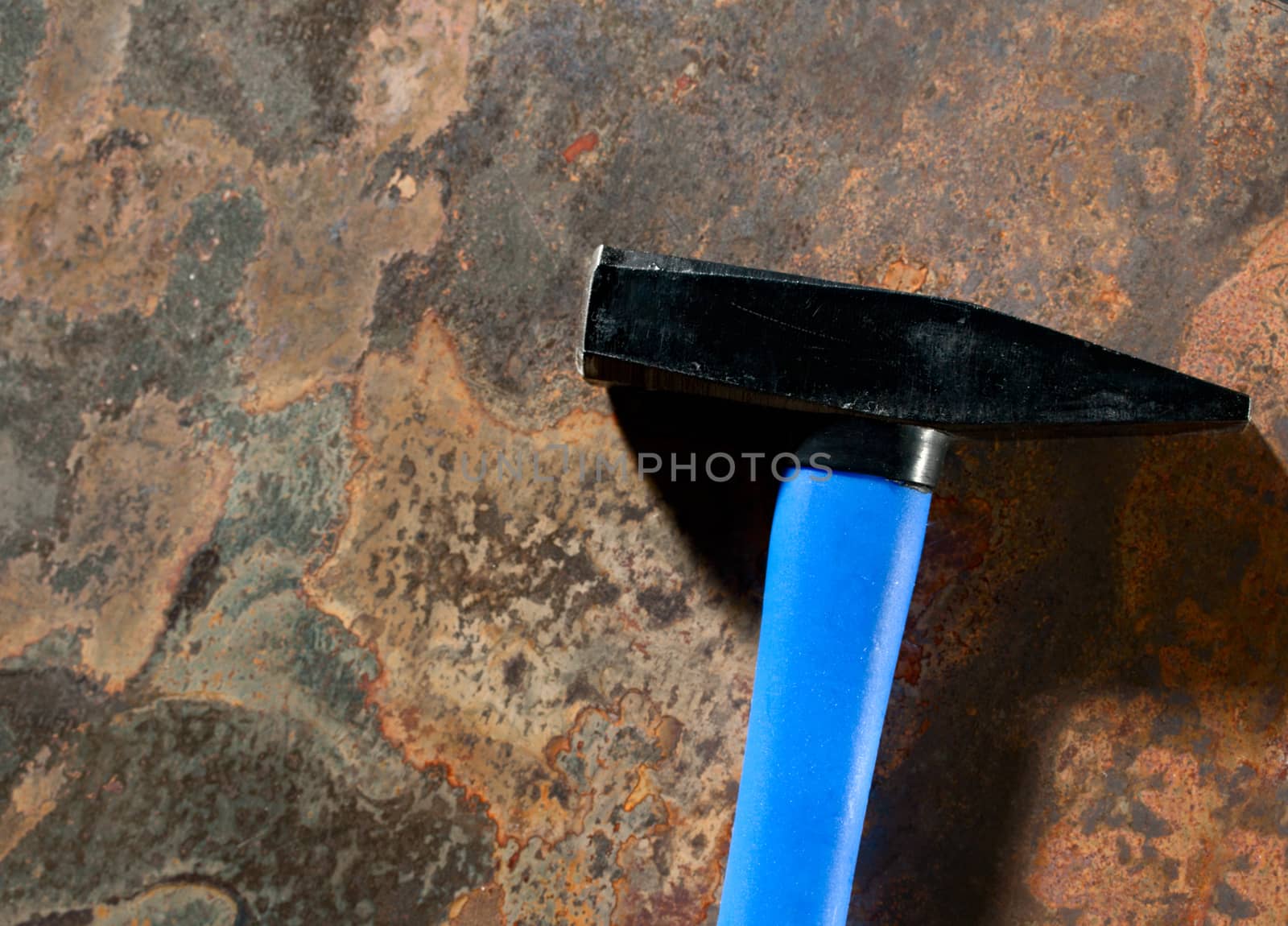 Hammer on the rusty background