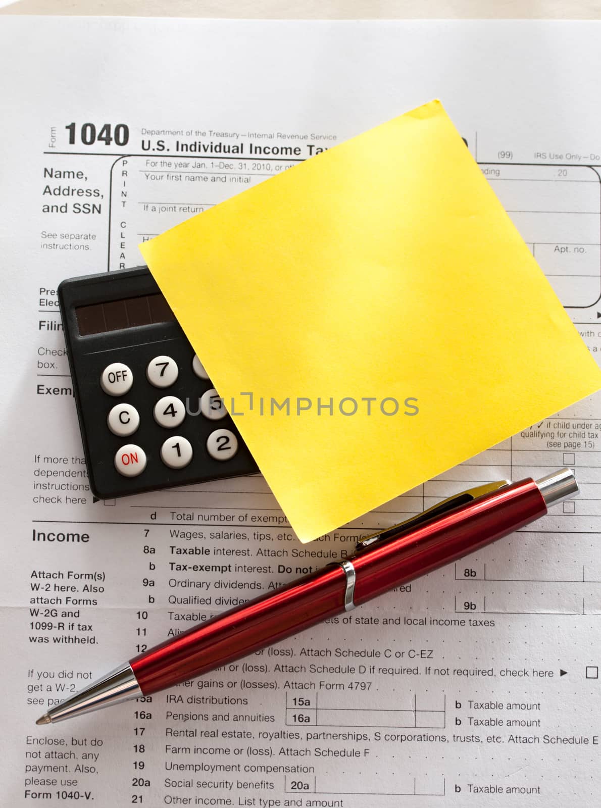 Tax form, red pen, calculator and sticker by Garsya