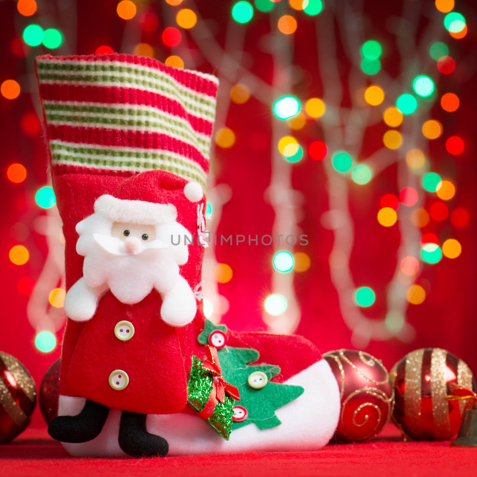 Christmas ornaments santa stocking with blurry glitter shiny lights at background.