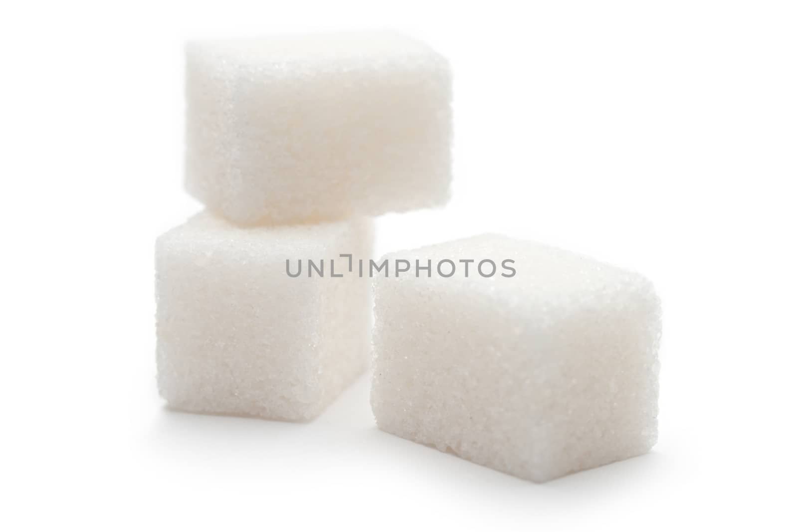 Cubes of sugar on the white background by Garsya