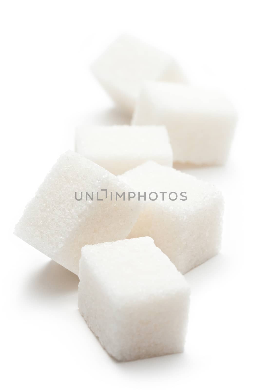 Cubes of sugar on the white background by Garsya