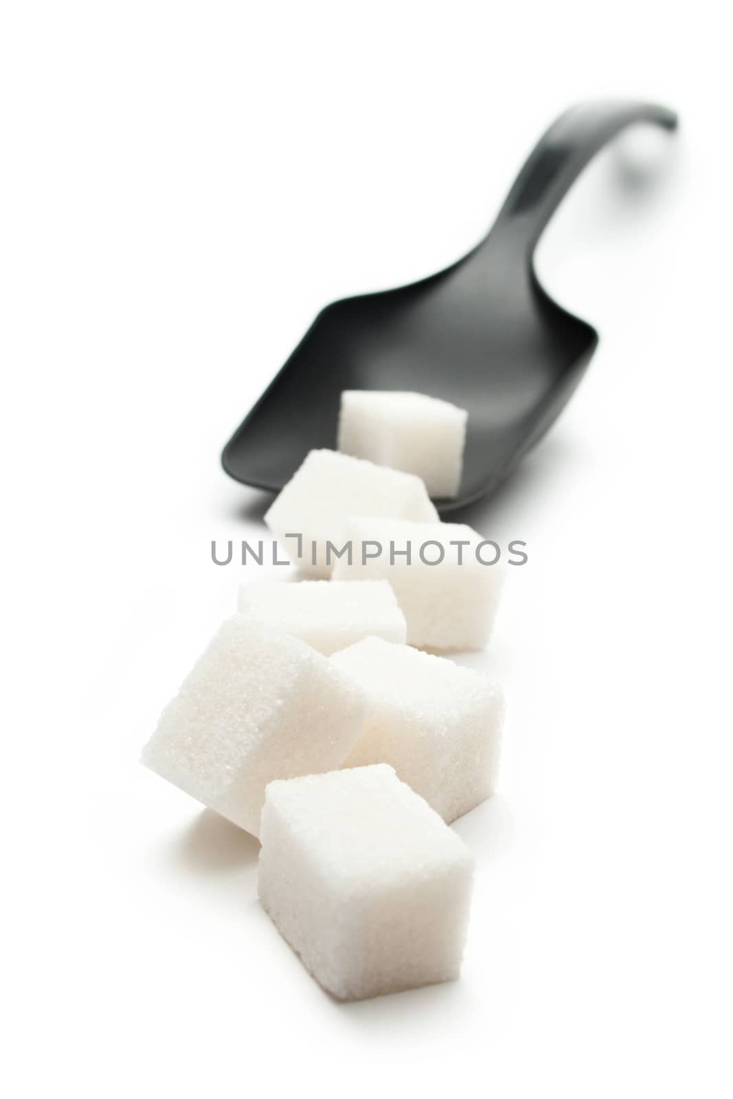 Cubes of sugar with plastic spoon by Garsya