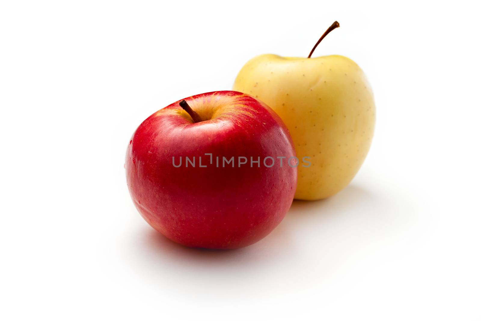 Red and yellow apples on white