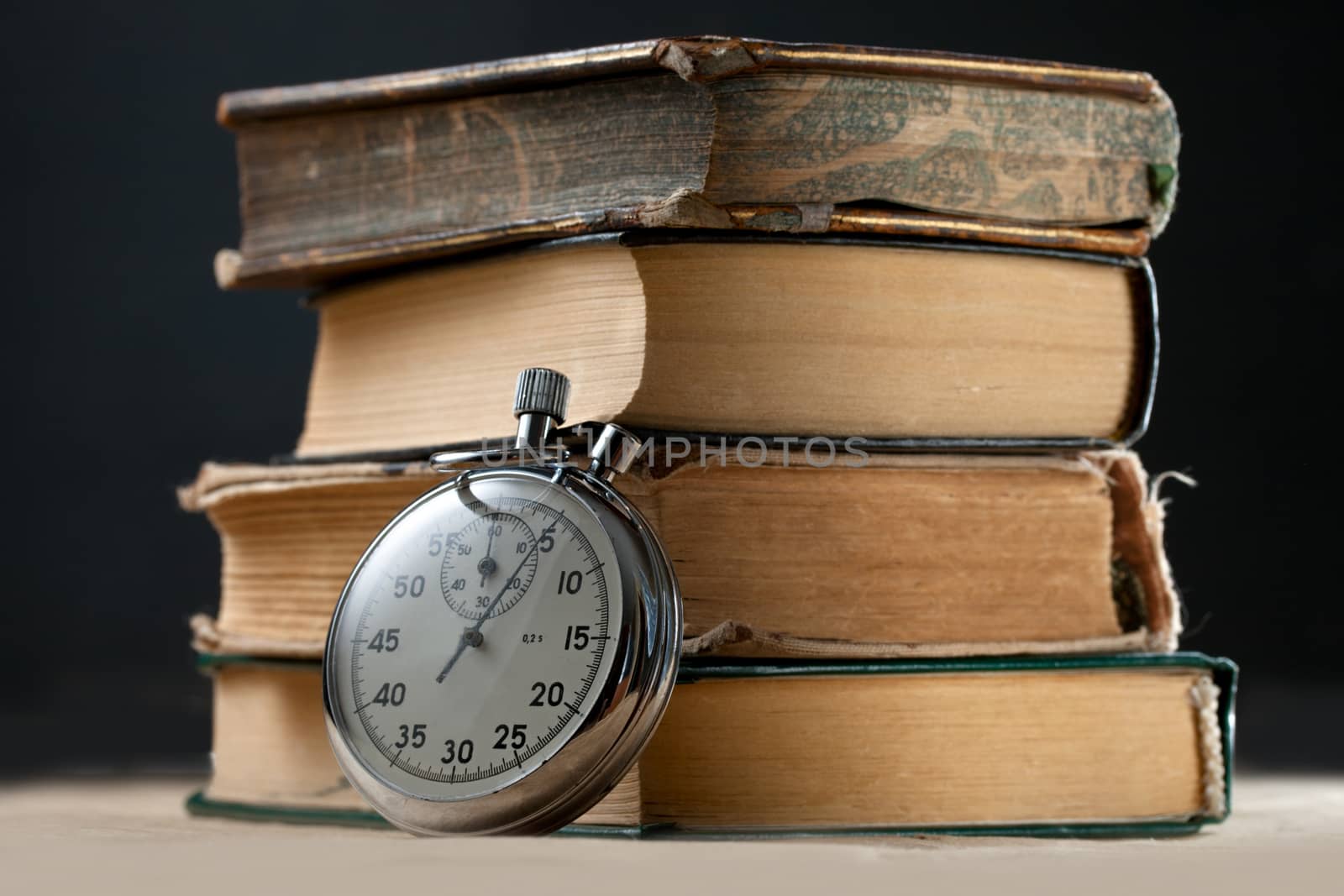 Pile of old books and stopwatch