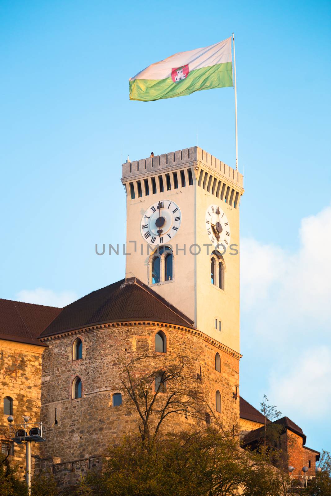 Clock tower of Ljubljana castle with town flag. Slovenia, Europe.