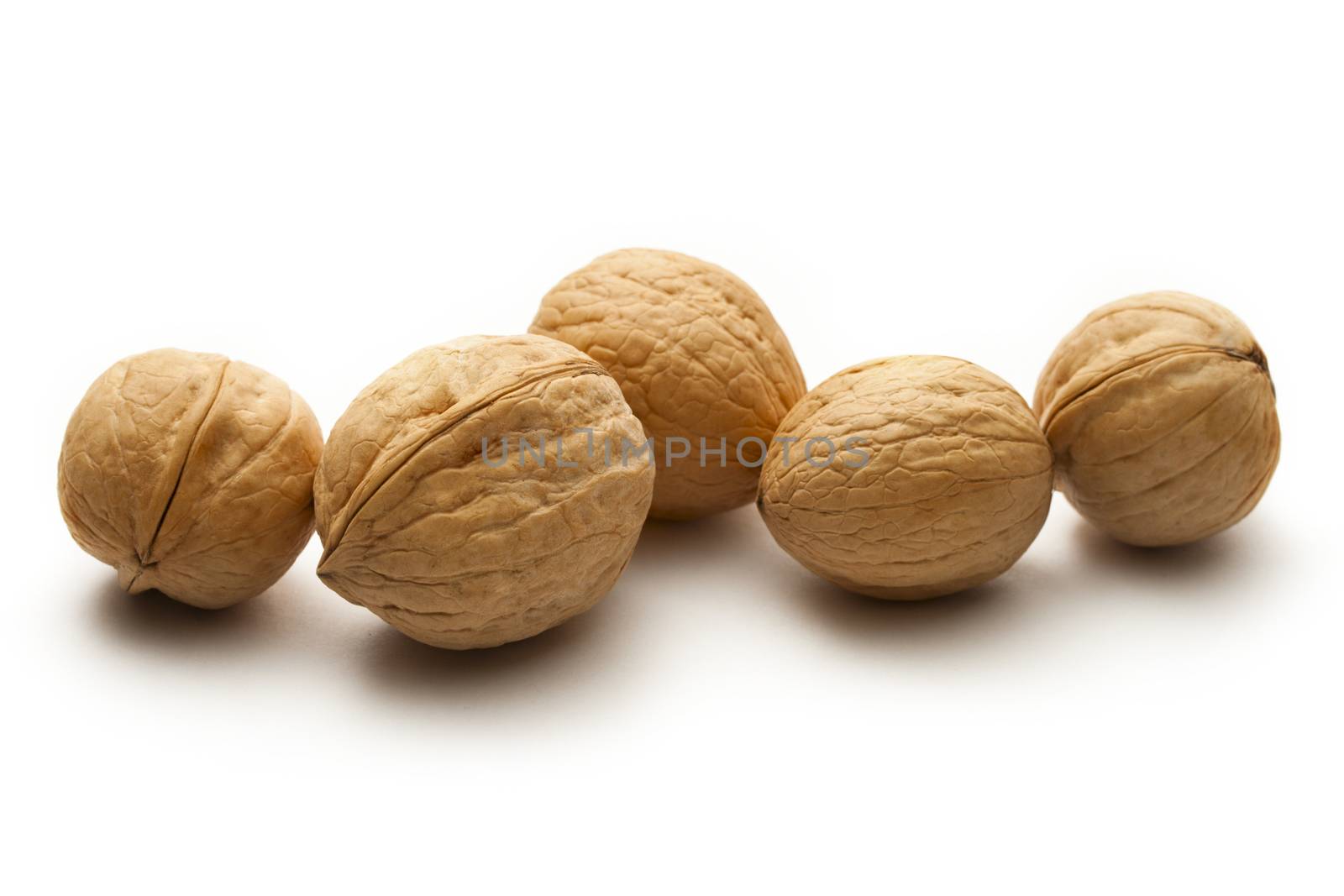 Heap of walnuts on white