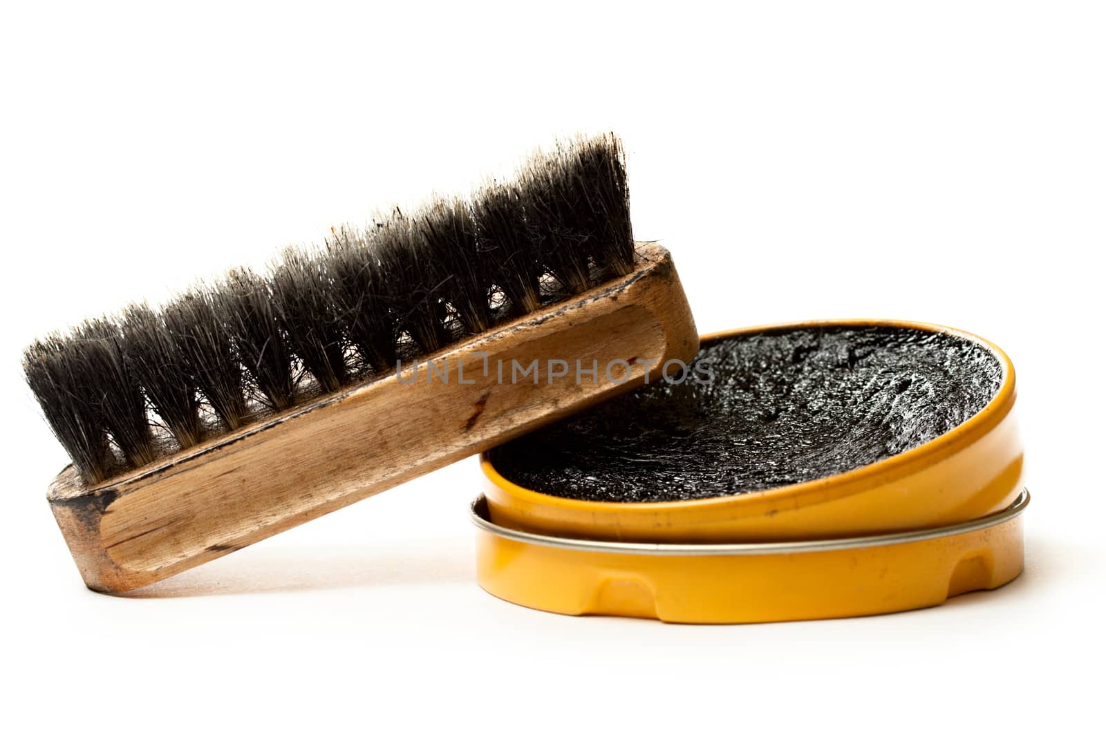 Shoe polish and brush on white by Garsya