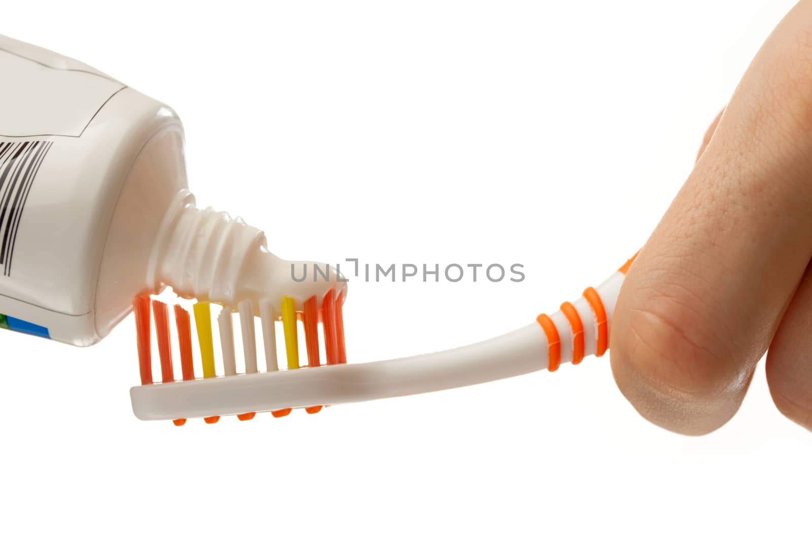 Toothbrush and toothpaste in female hands by Garsya