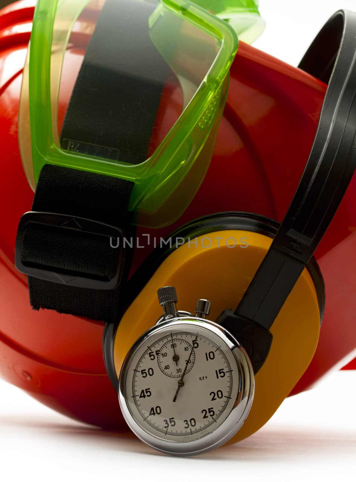 Red safety helmet with earphones, goggles and stopwatch