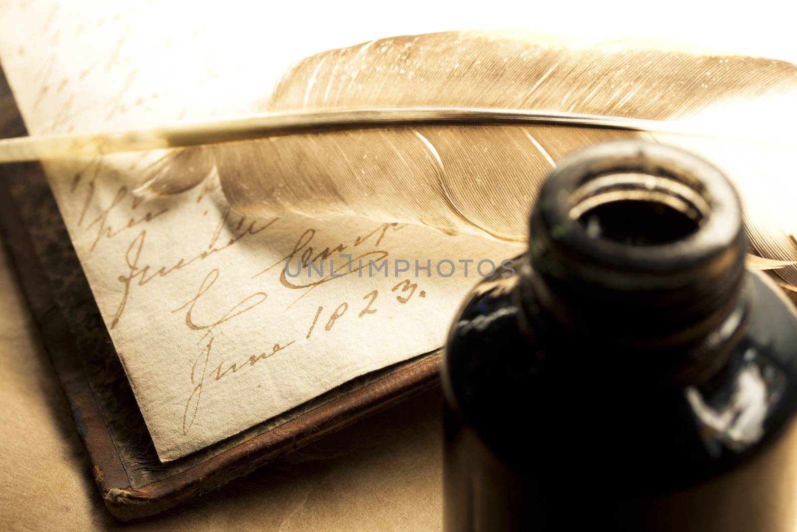 Old book with feather and inkpot by Garsya