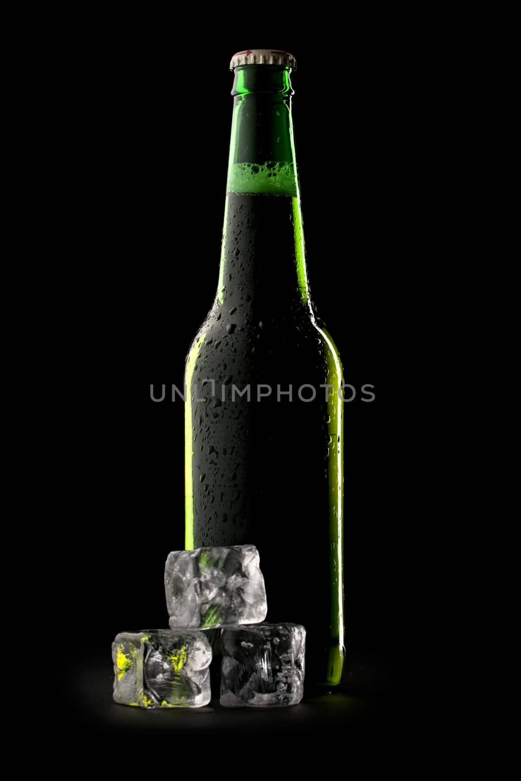 Bottle of beer with ice cubes by Garsya