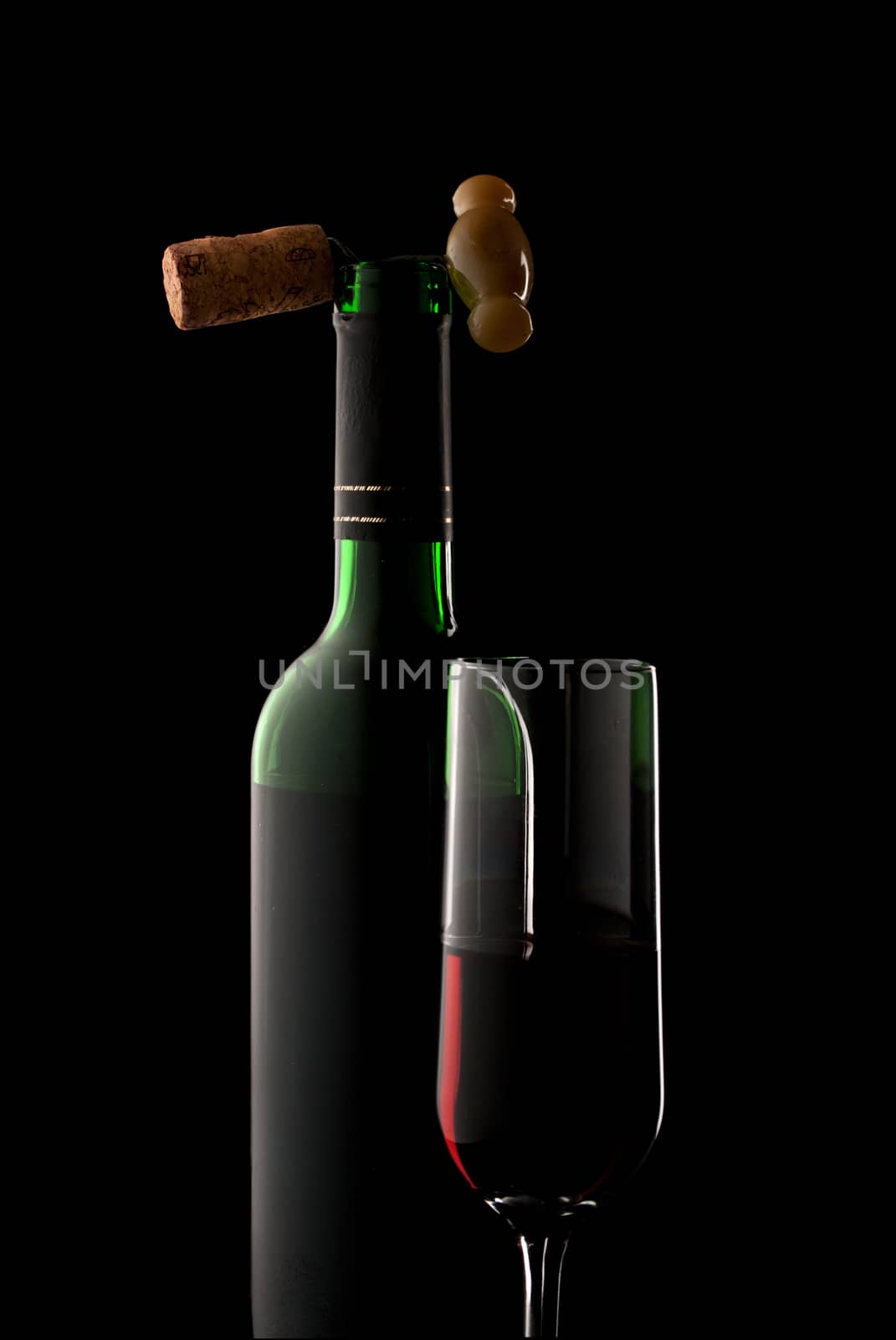 Bottle and glass of wine in black