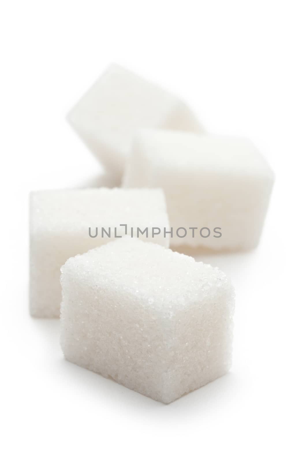 Cubes of sugar on the white background