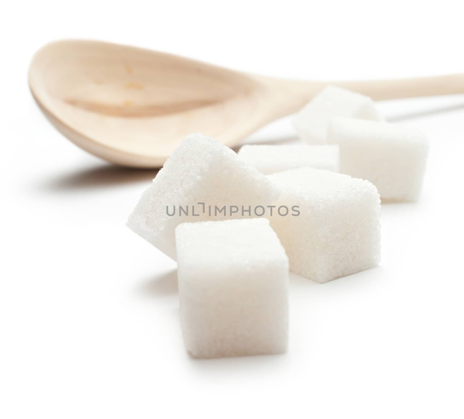 Cubes of sugar with wooden spoon