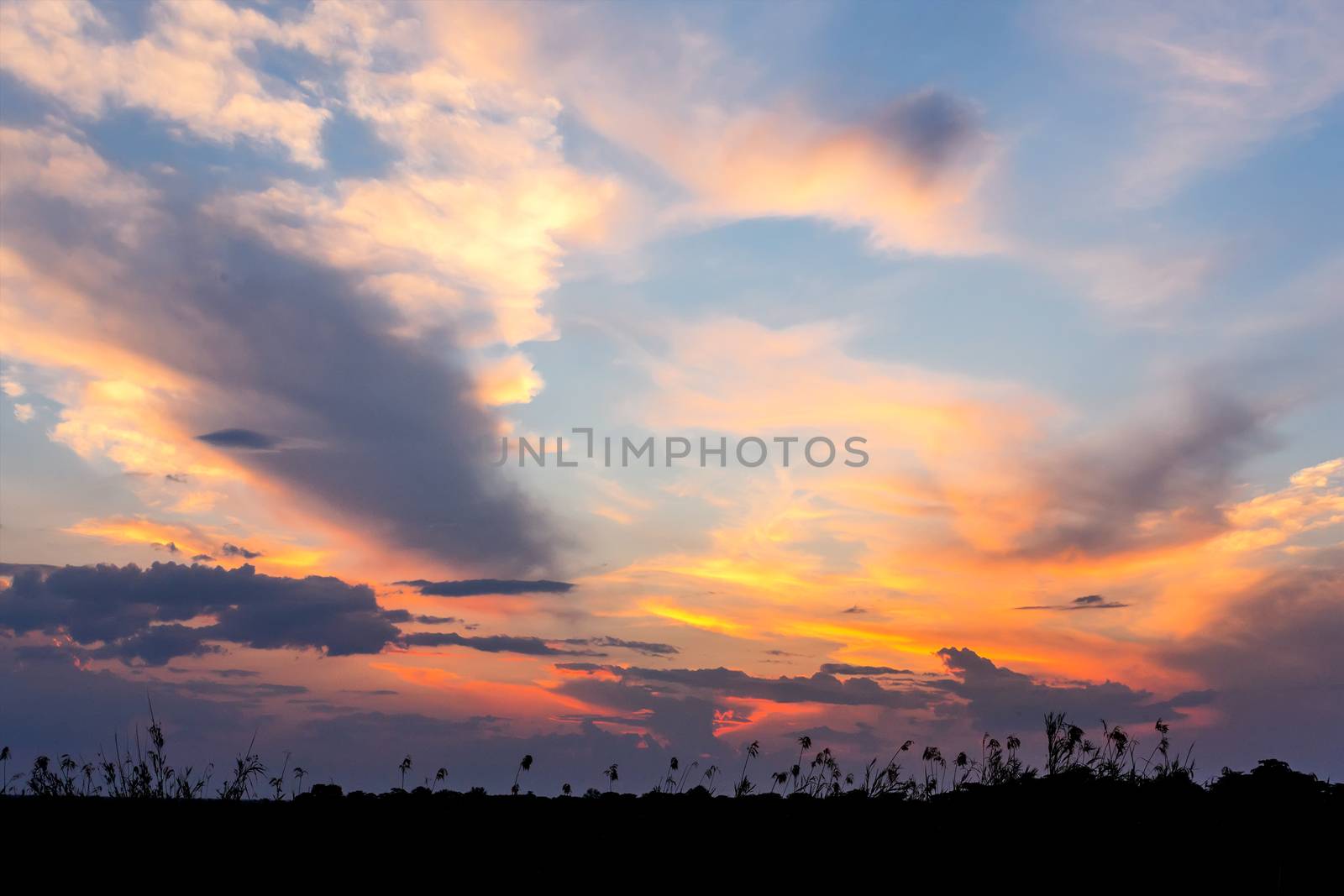 African sunset with dramatic clouds on sky, Kavango Namibia