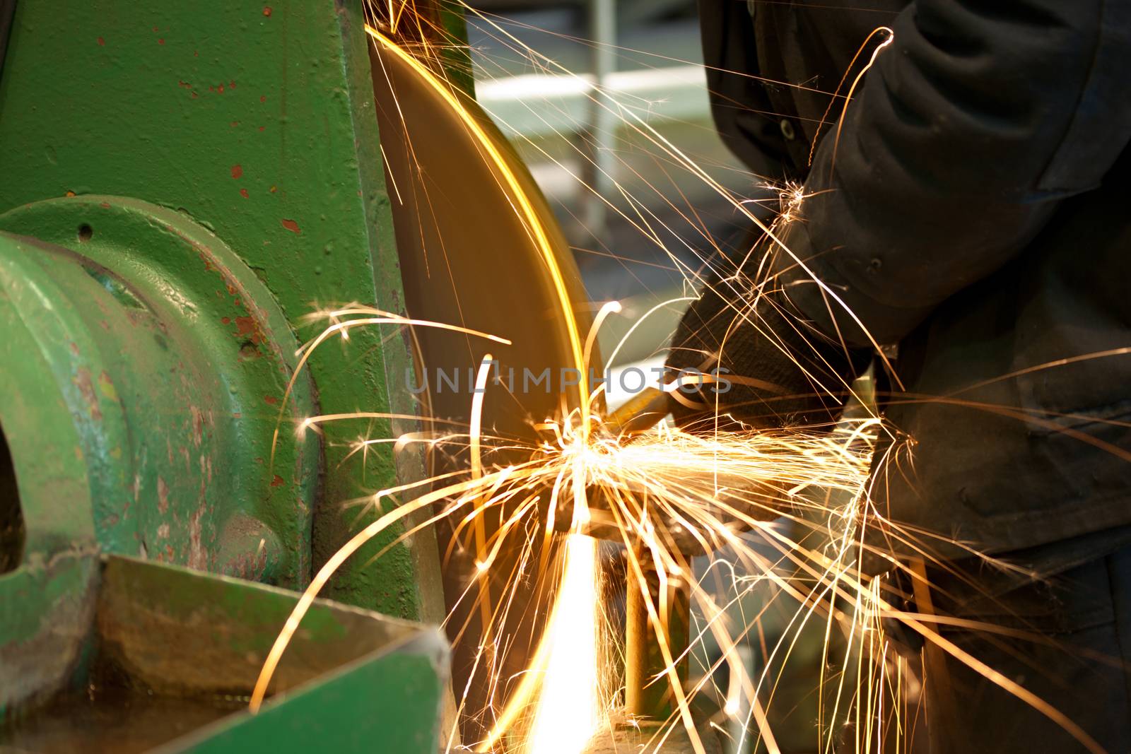 Emery in process in machinery workshop