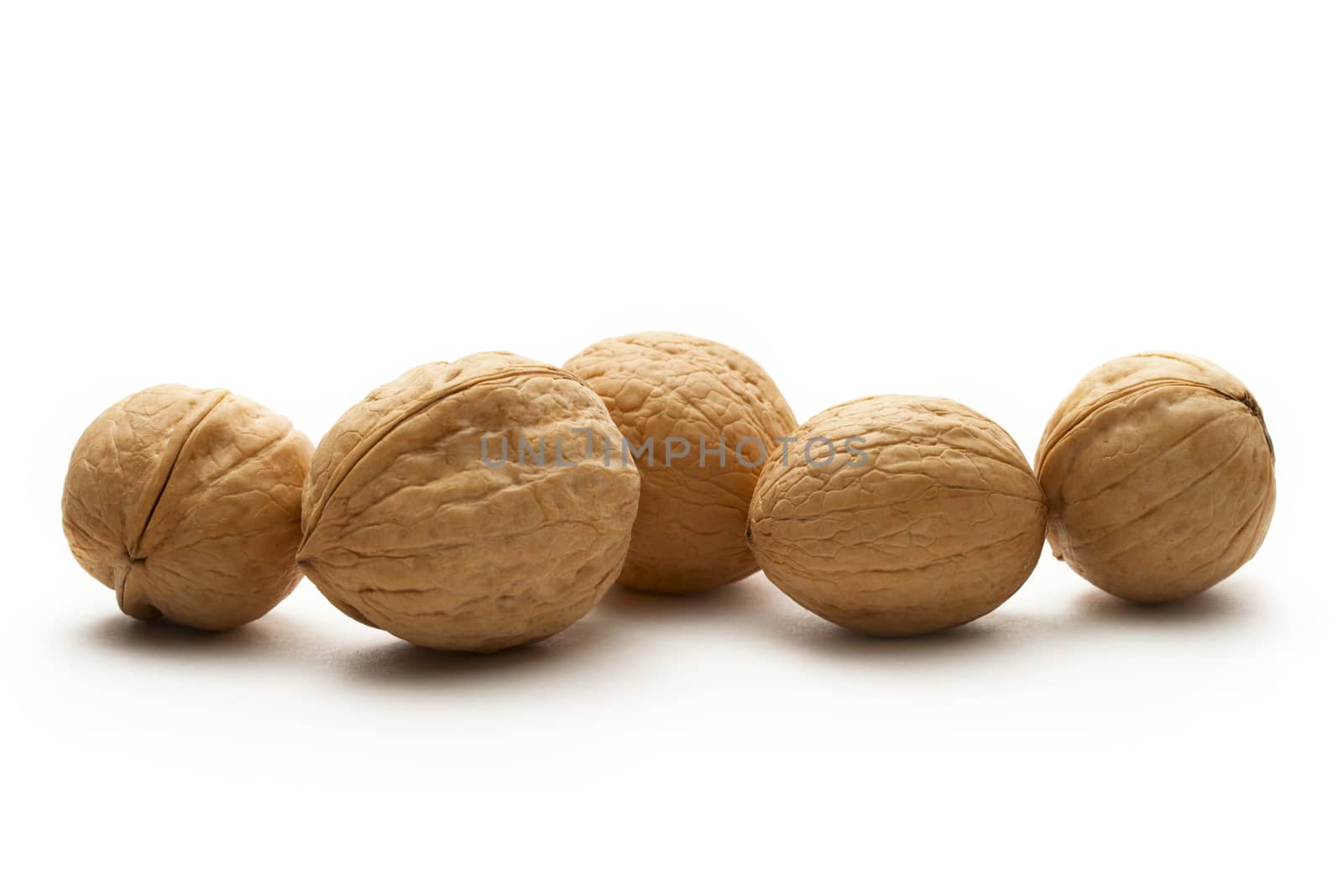 Heap of walnuts on white