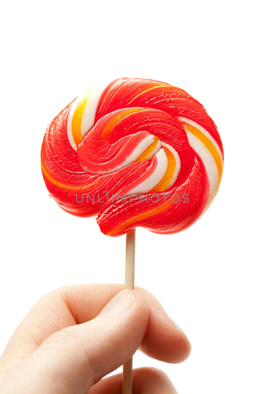 Bright lollipop candy in hand by Garsya