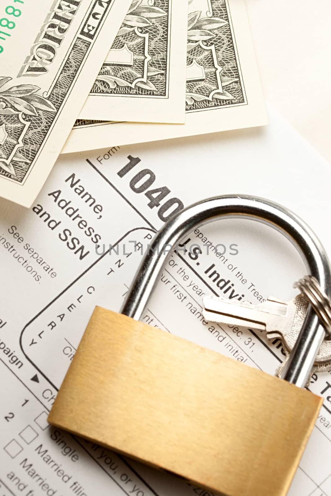 Tax form, dollars and key lock 