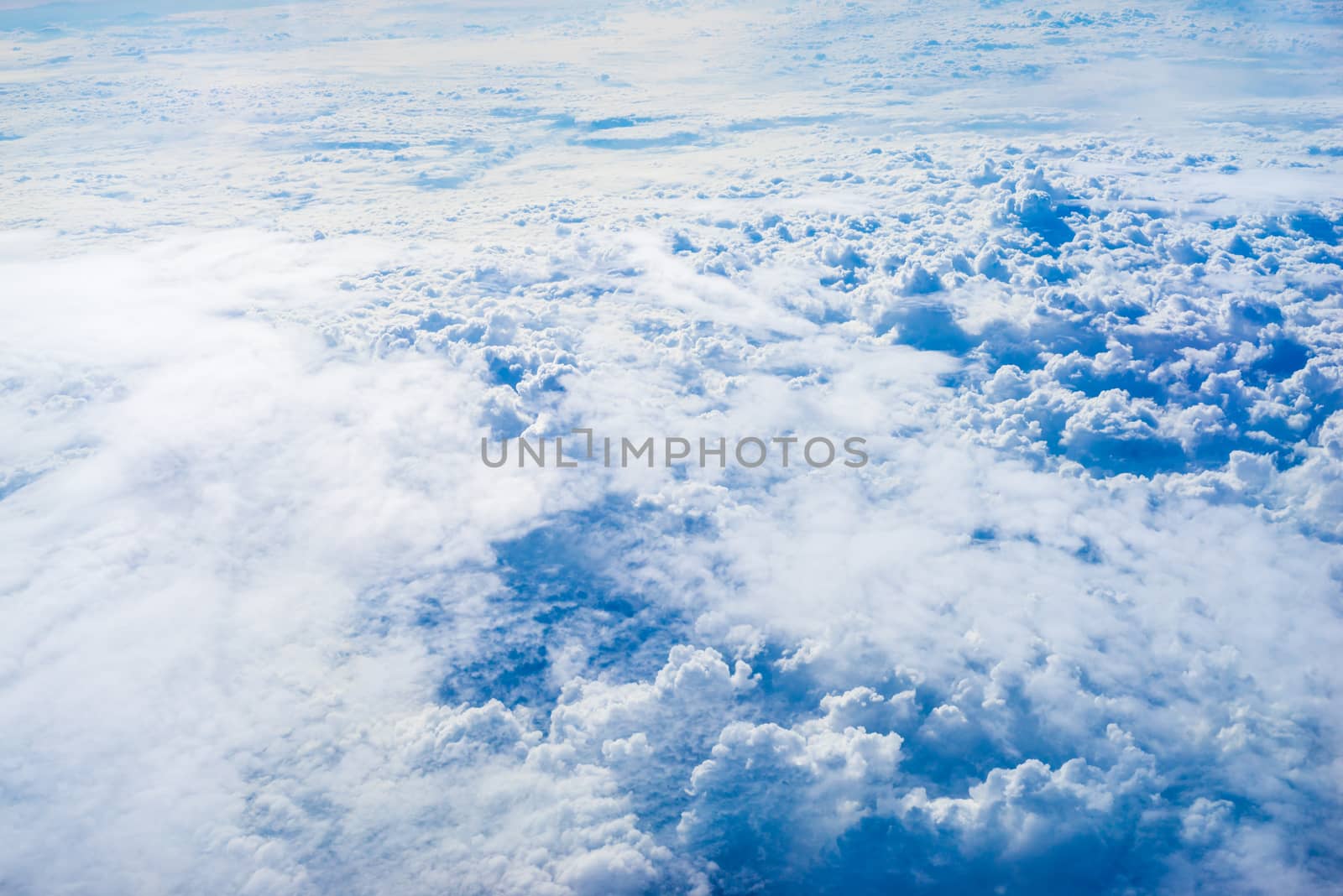 The View from the plane window above the cloud and blue sky