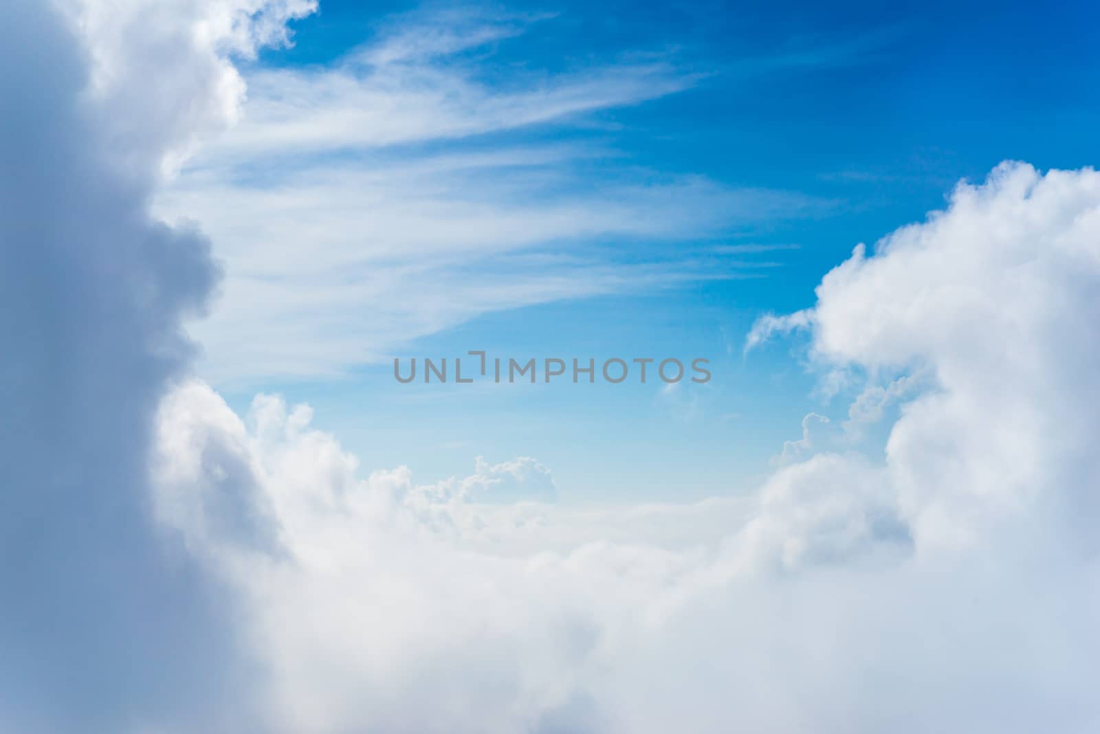 The View from the plane window above the cloud and blue sky