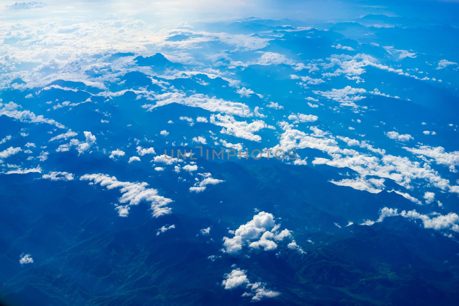 The View from the plane window above the cloud and blue sky