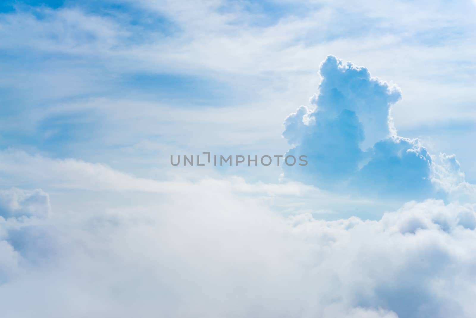 The View from the plane window above the cloud and blue sky