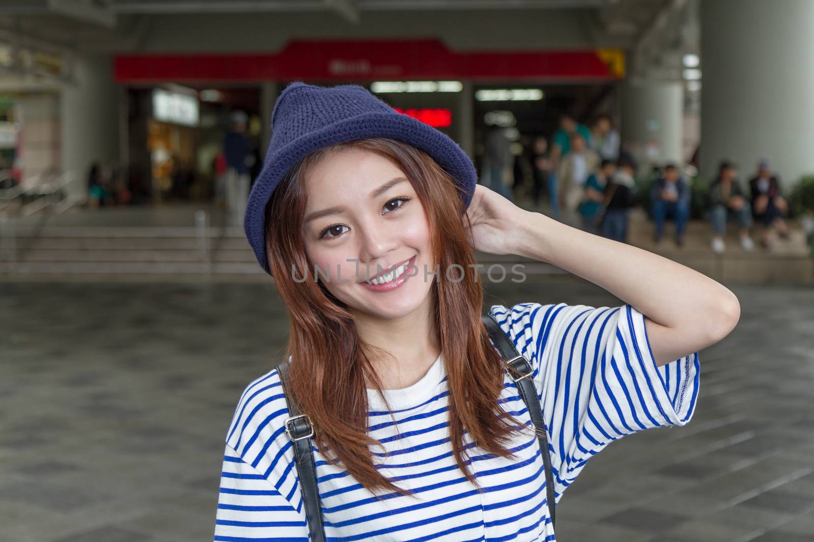 Asian woman outside subway station by imagesbykenny