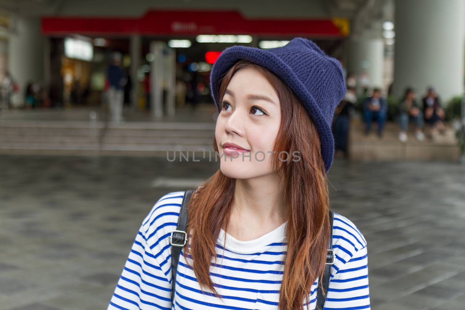 Asian woman outside subway station by imagesbykenny