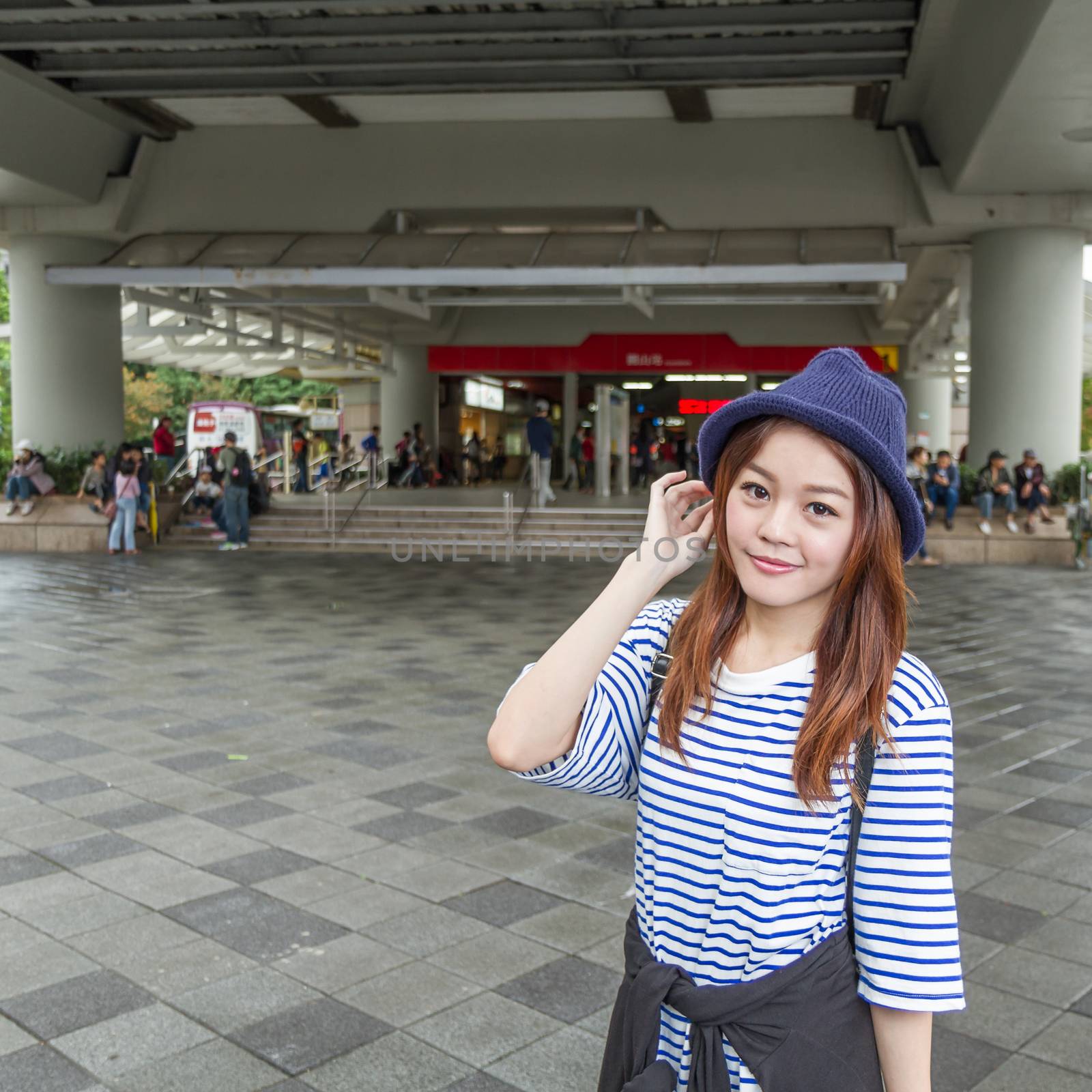 Asian woman outside subway station by imagesbykenny