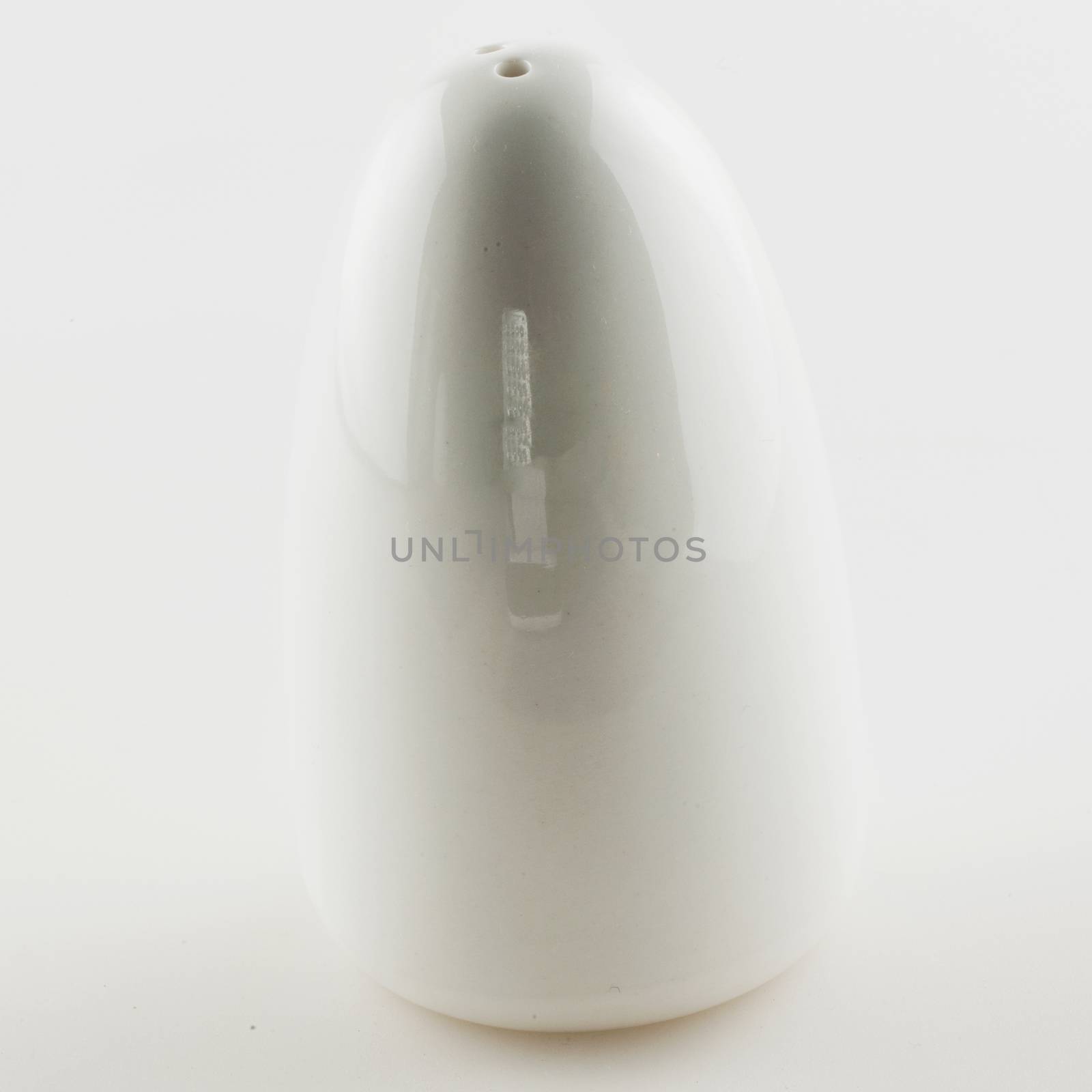 White salt cellar over white background, square image