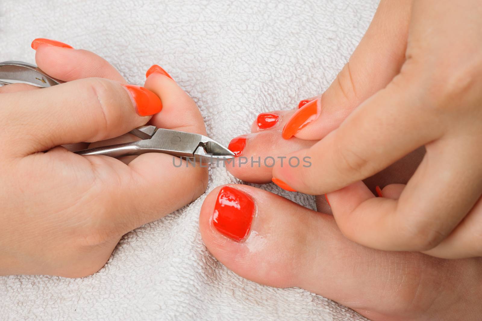 cutting cuticlle on toe with scissors, pedicure process closeup