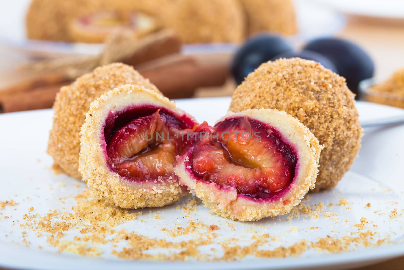 Close up of delicious sweet plum dumplings on white plate